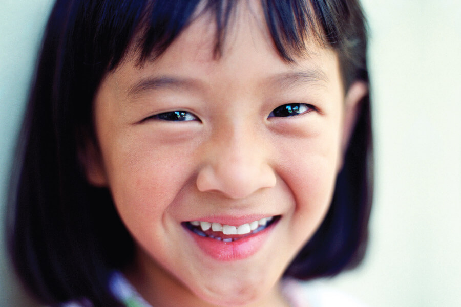 Closeup of a little Asian girl smiling in Eden Prairie, MN