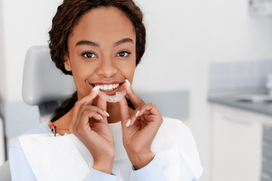 girl holding a clear aligner