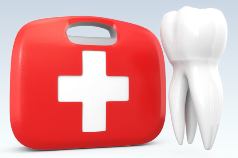Dental emergency kit next to a model of an oversized tooth.