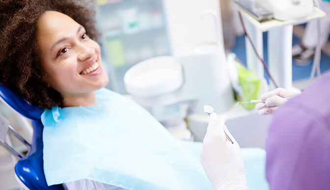 woman about to have her teeth examined by her dentist