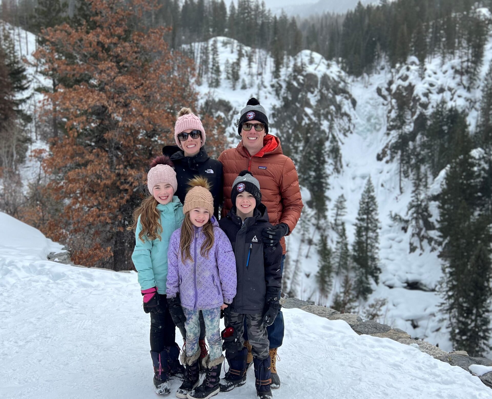 Family with a mountain backdrop smiling