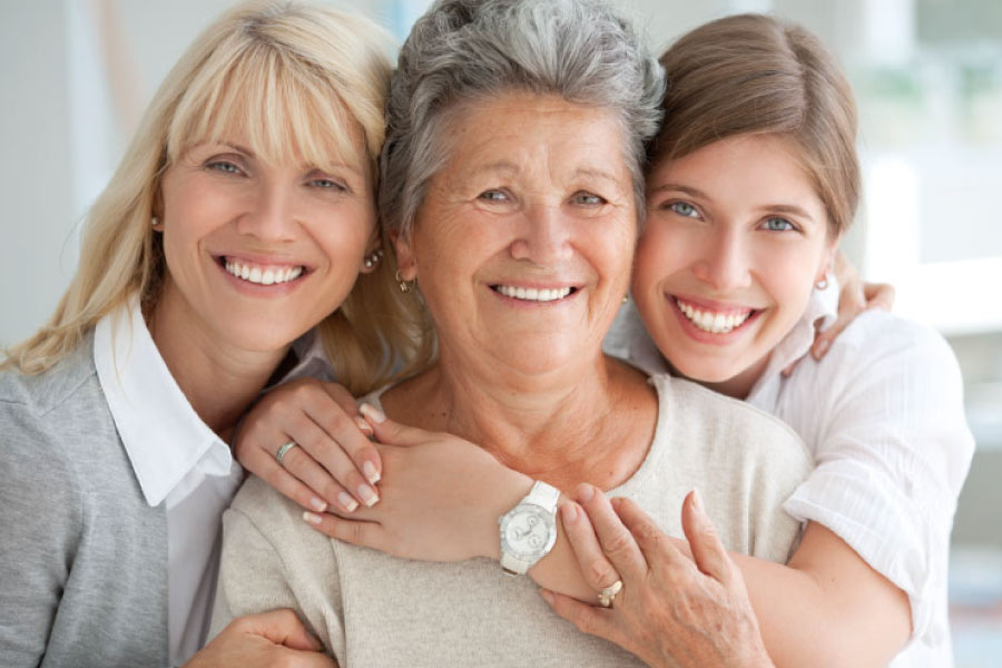 Three generations of smiling women.