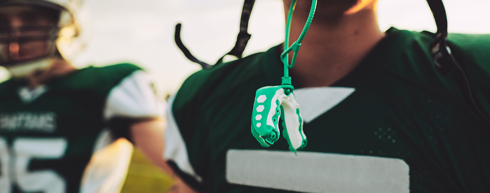 mouthguard hanging from a football player's helmet